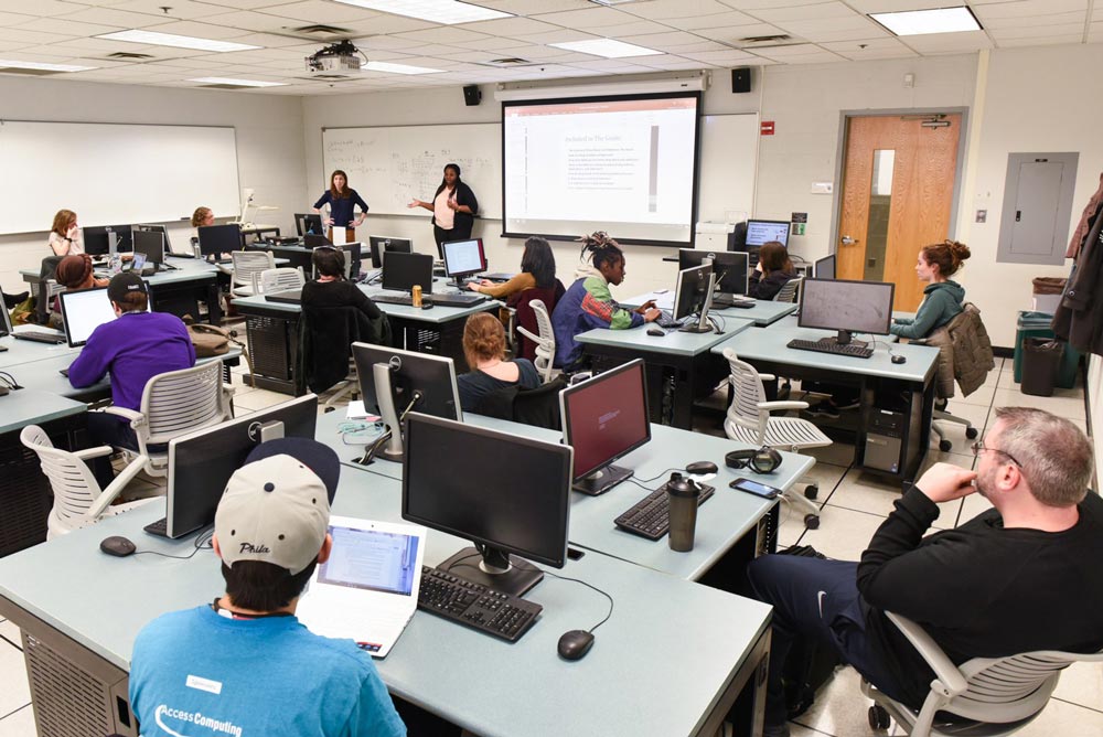 A teacher teaching a classroom of students 