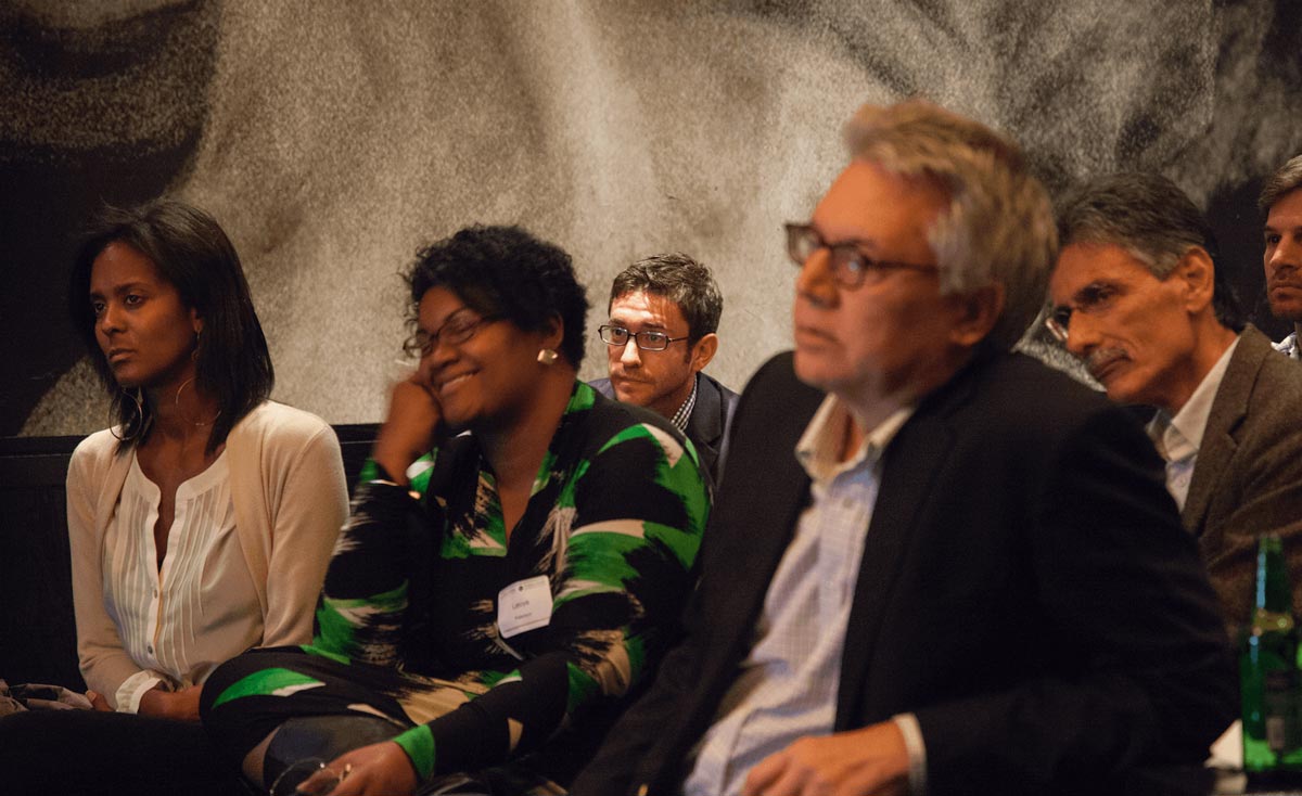 Several people sitting in a meeting