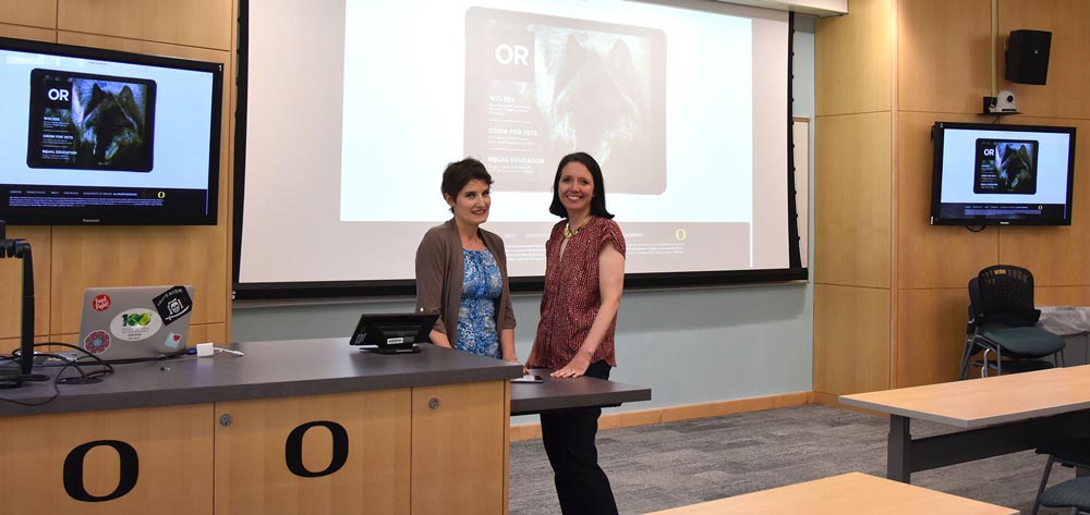 Two people standing together in a classroom