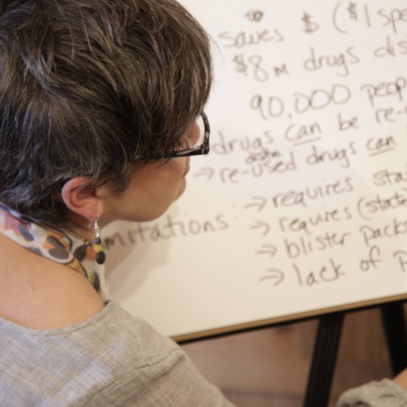 Woman writes on a poster