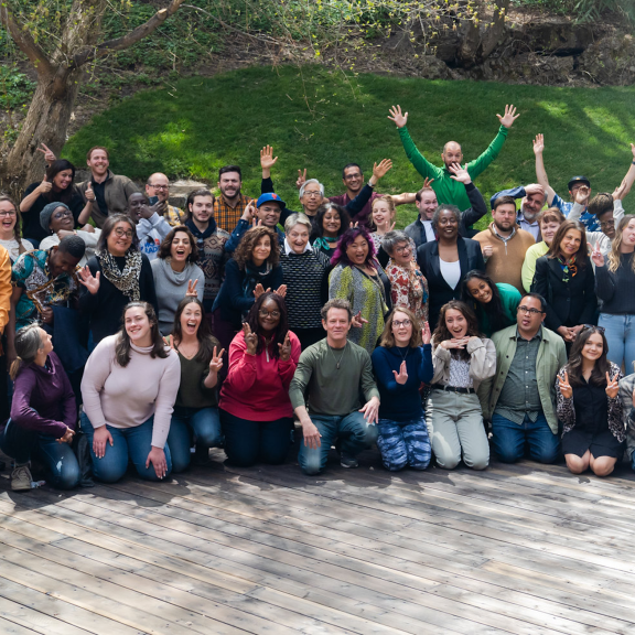 Participants in an SJN Summit smile and pose for the camera