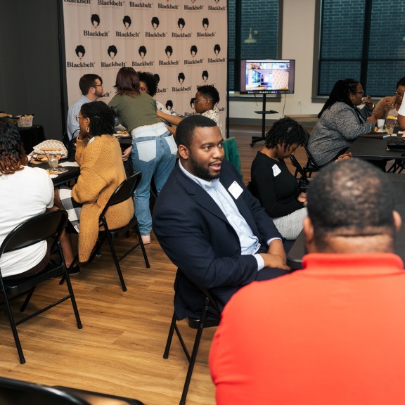 Participants in a Student Media Challenge event speak with each another