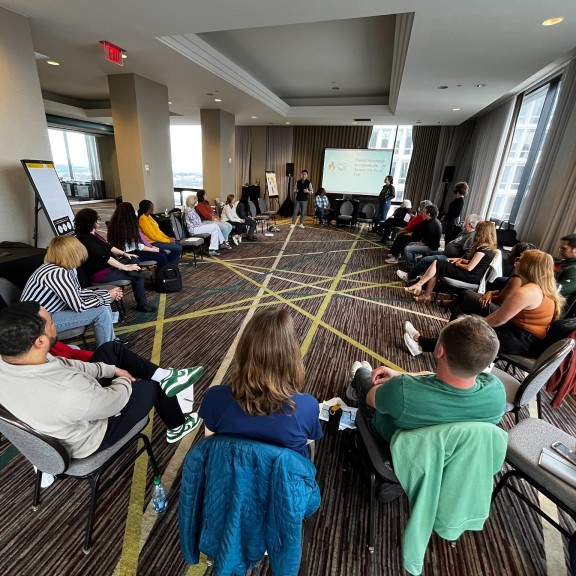 People sit in a circle during a presentation