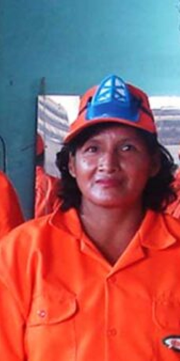 Three people pose in orange coverall suits