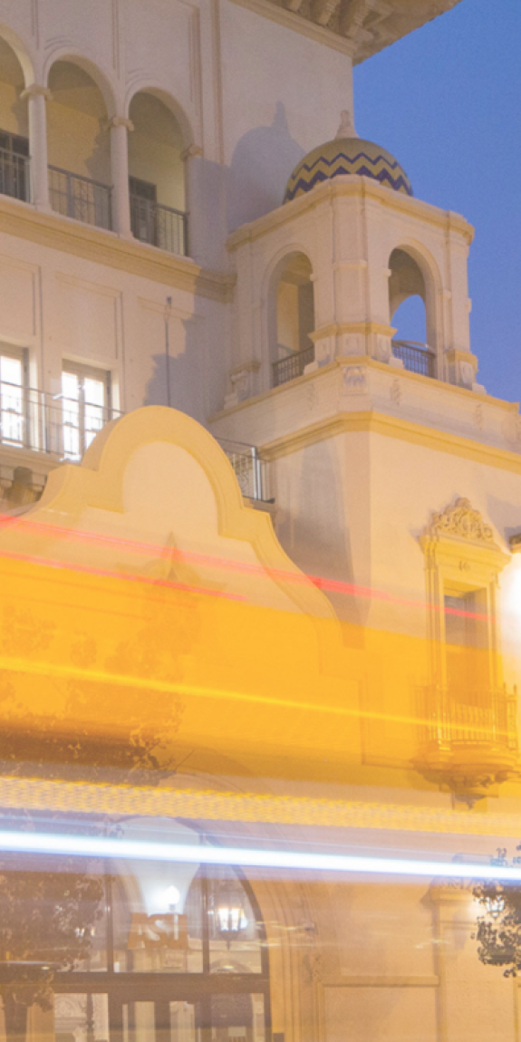 The California Center building is illuminated in bright golden light