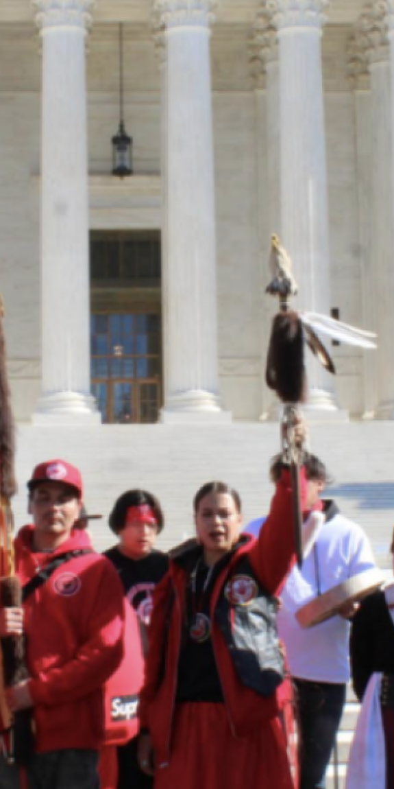 People gather in front of a building