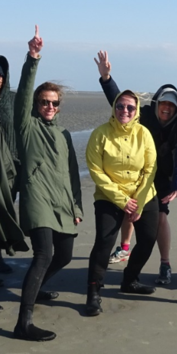 People pose for a photo on the beach