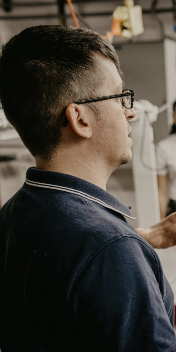 A man speaks to a group of journalists
