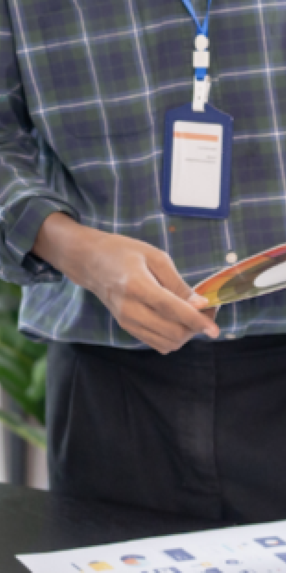 People stand at a table reviewing notes