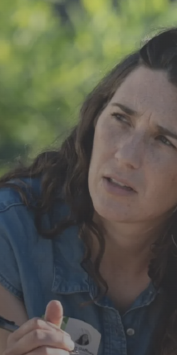 A women interviews a man and takes notes