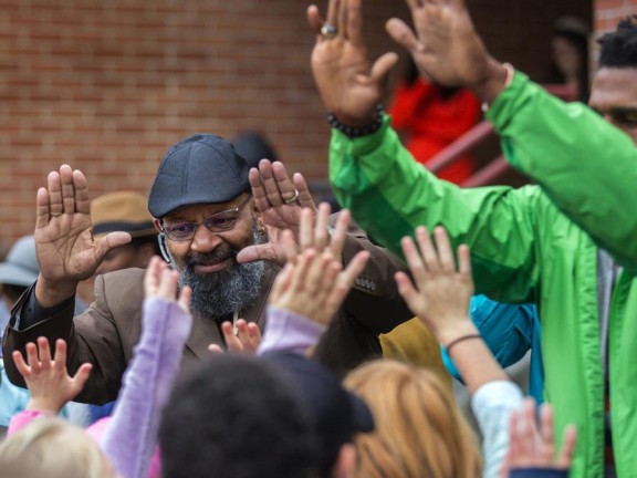 teachers and students raising ther hands