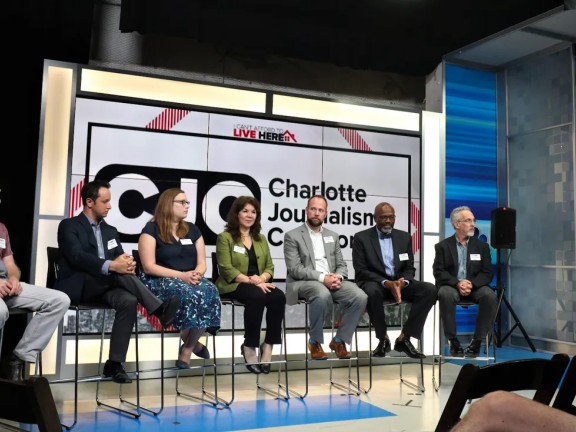 From left: CJC members Jim Yarbrough (of QNotes), Nate Morabito (WCNC), Lauren Lindstrom (Charlotte Observer), Hilda Gurdian (La Noticia), Seth Ervin (Charlotte-Mecklenburg Library), Glenn Burkins (QCityMetro), and David Boraks (WFAE). They are taking questions from co-moderator and WCNC anchor Fred Shropshire during an event in pre-pandemic times. (Photo courtesy Michael Davis)