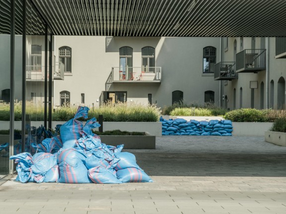 Sandbags are stacked outside an apartment building