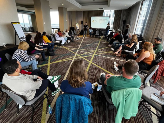 SJN staff members gather in a circle during a team retreat