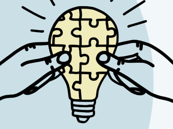 Two hands hold a lightbulb, which is covered in a puzzle piece pattern