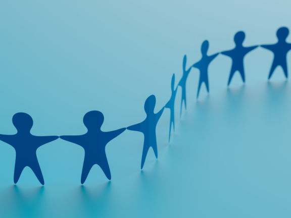 A paper chain of people touching hands