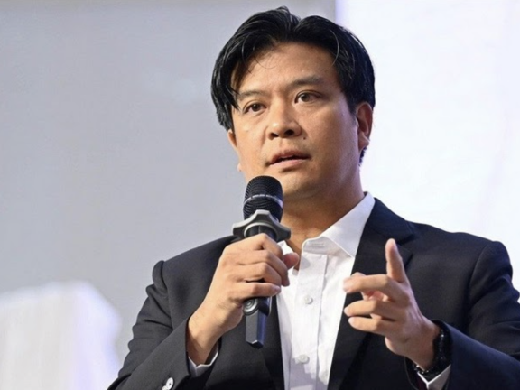 A man speaks into a microphone
