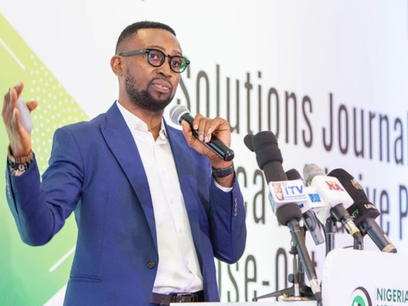 Chibuike Alagboso speaks into a microphone