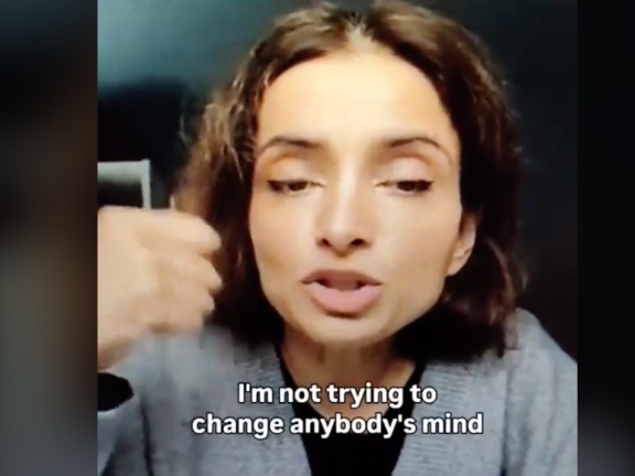 A woman speaks on camera saying "I am not trying to change anybody's mind"