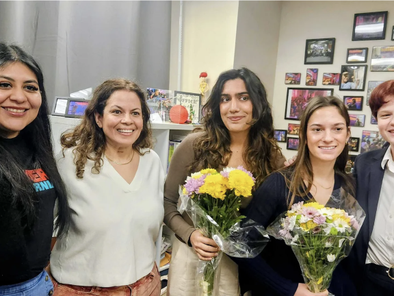 Five people pose for a photo. Photo courtesy of KALW