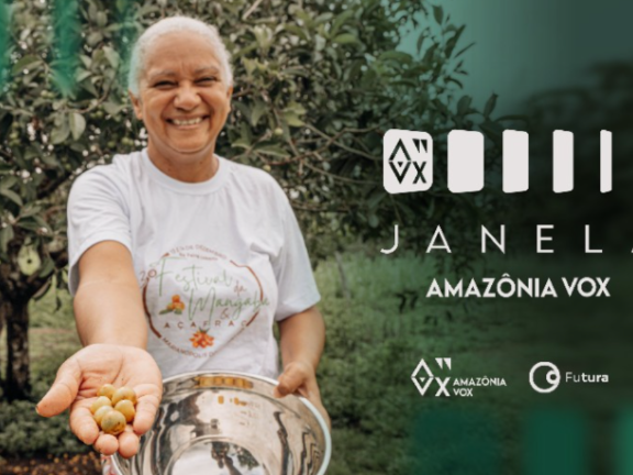 A smiling woman extends her handful of fruit