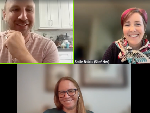 Three people smile in a Zoom webinar