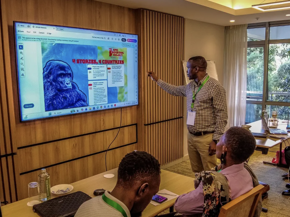 A man points to a presentation