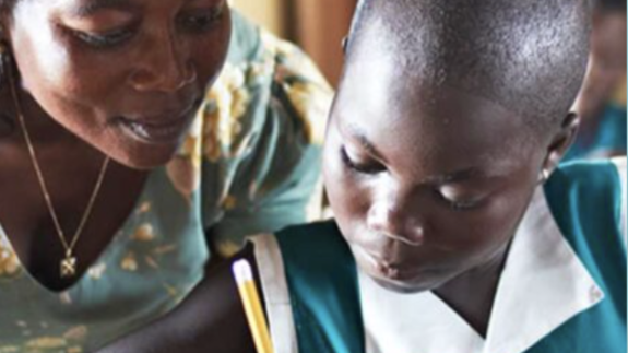 A teacher helps a student with their work