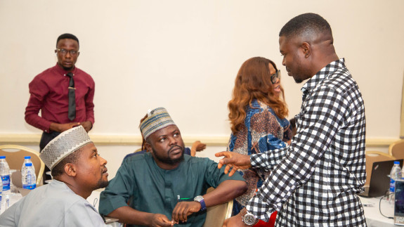 3 men talking around a table