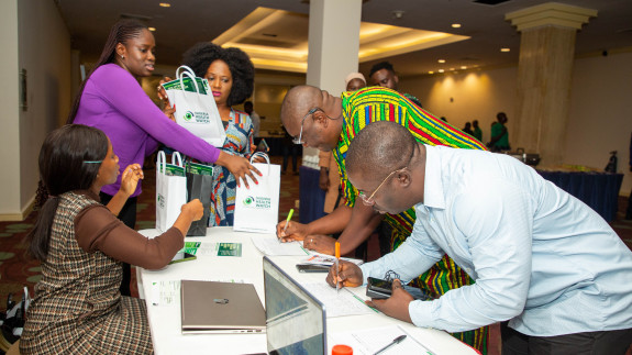 5 people around a table talking