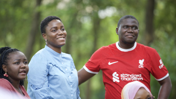 3 people standing and smiling