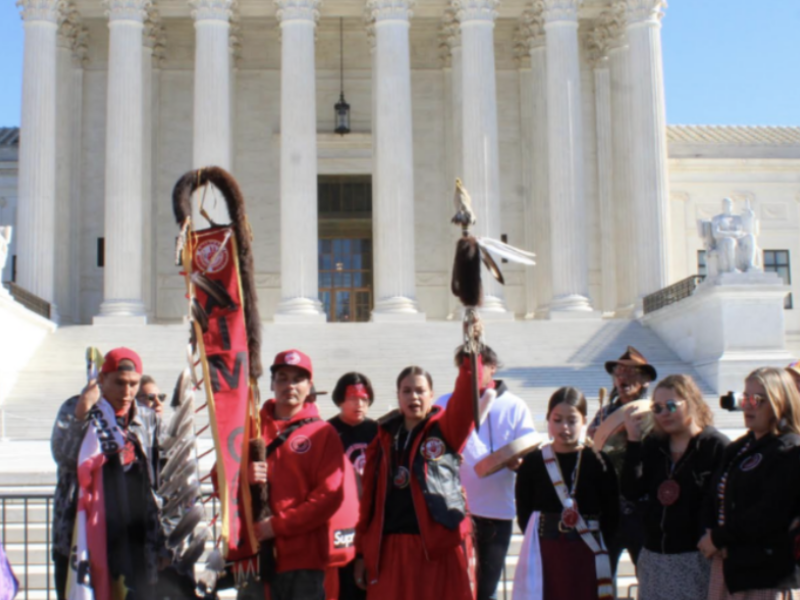 People gather in front of a building