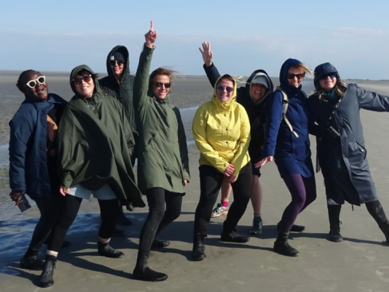 People pose for a photo on the beach