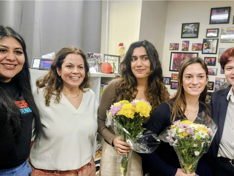 Five people pose for a photo. Photo courtesy of KALW
