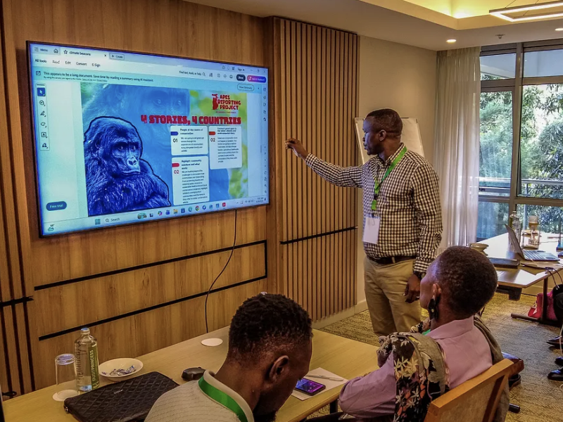 A man points to a presentation