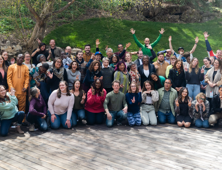 Participants in an SJN Summit smile and pose for the camera