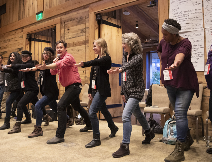 People do an exercise at an SJN Summit