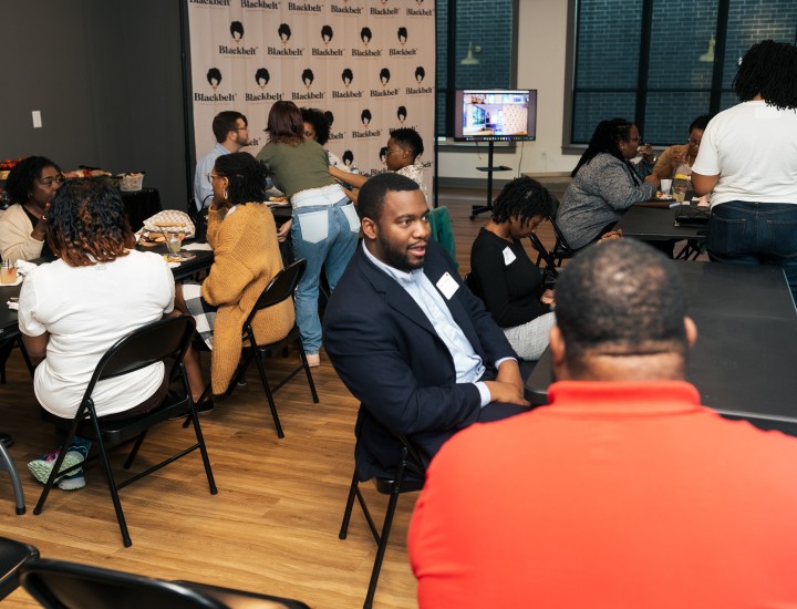 Participants in a Student Media Challenge event speak with each another