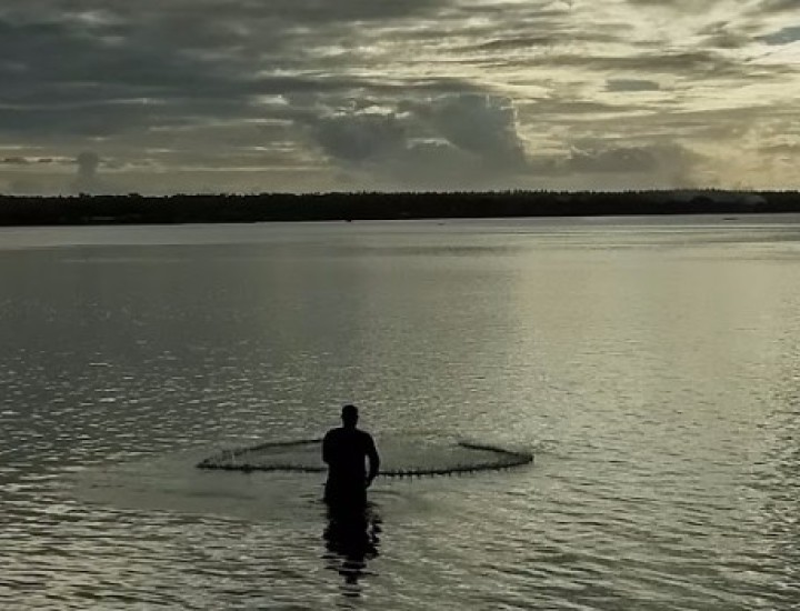 A man casting a fishing net.