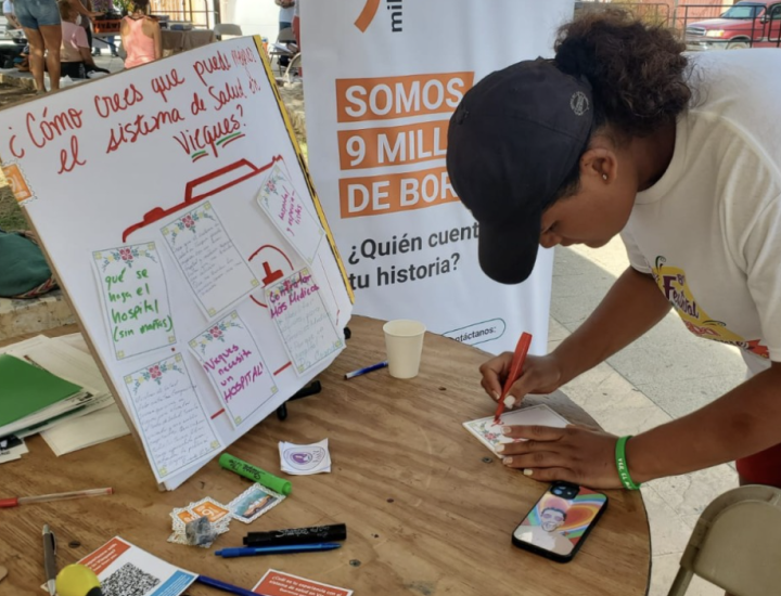 9 Millones table at the Vieques Arepa Festival, where we were conducting a survey. (2024. Photo taken by Lymarie Rodríguez)
