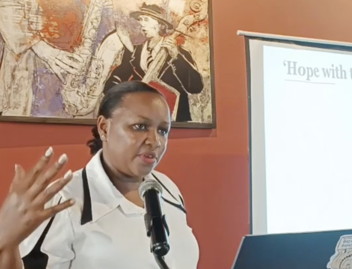 Caroline Karobia speaks at a podium during the "Media Science Cafe" event