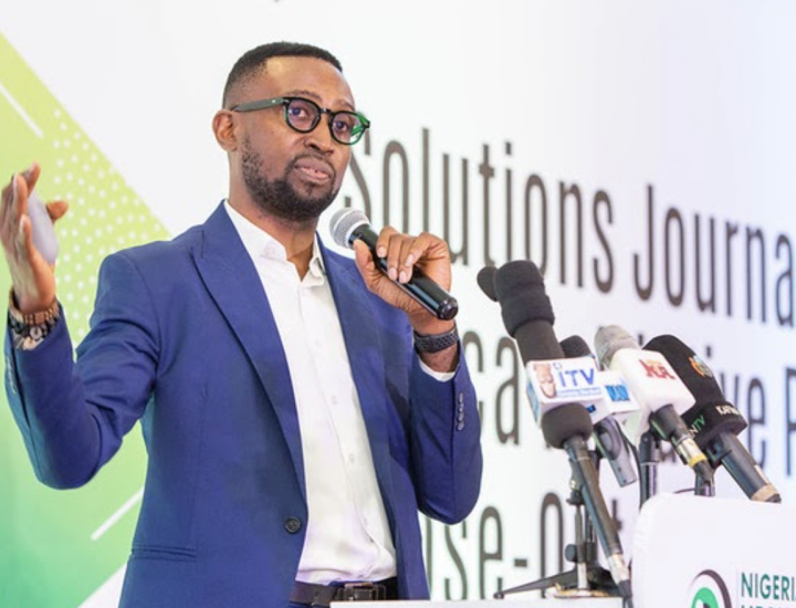 Chibuike Alagboso speaks into a microphone