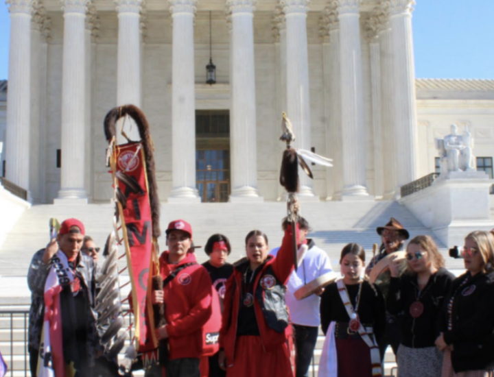 People gather in front of a building