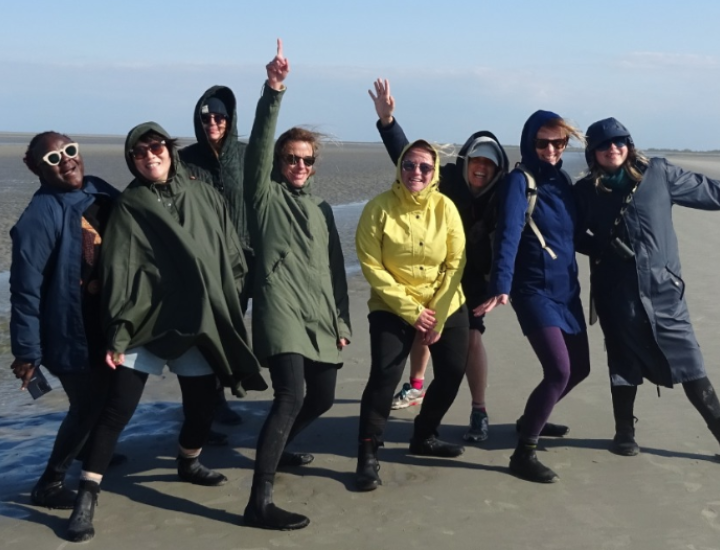 People pose for a photo on the beach