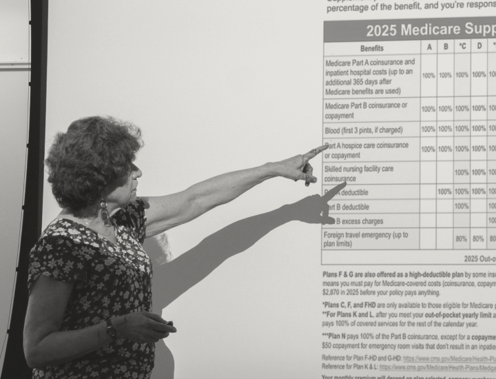 A woman points to a presentation showing Medicare supplement plans