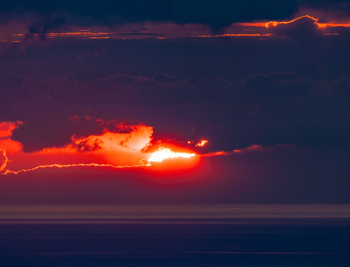 The sun shines from behind clouds