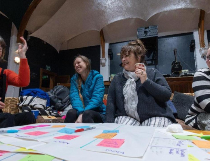 People collaborate at a table full of sticky notes